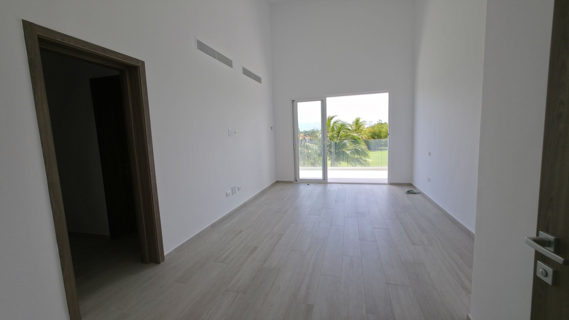 Bedroom with glass doors to balcony and views
