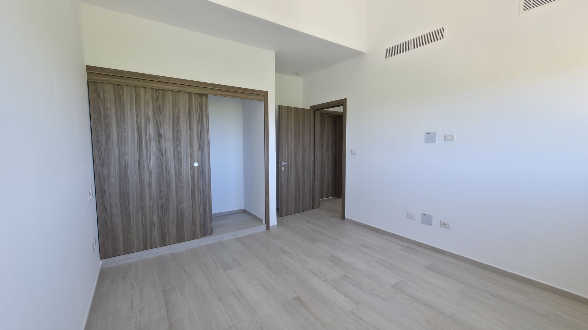 Master bedroom with closet and balcony access