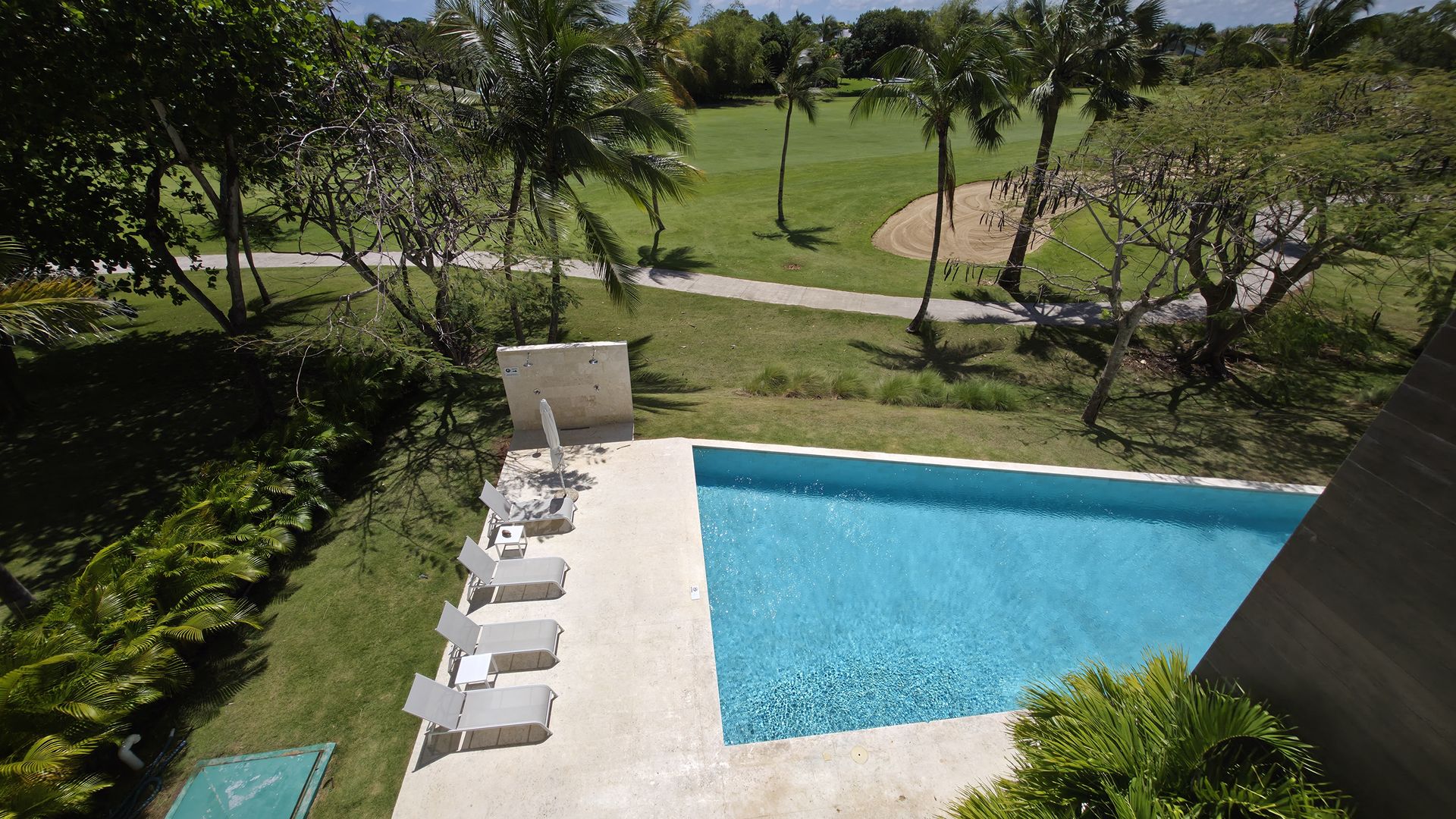 Pool deck with loungers and landscape view