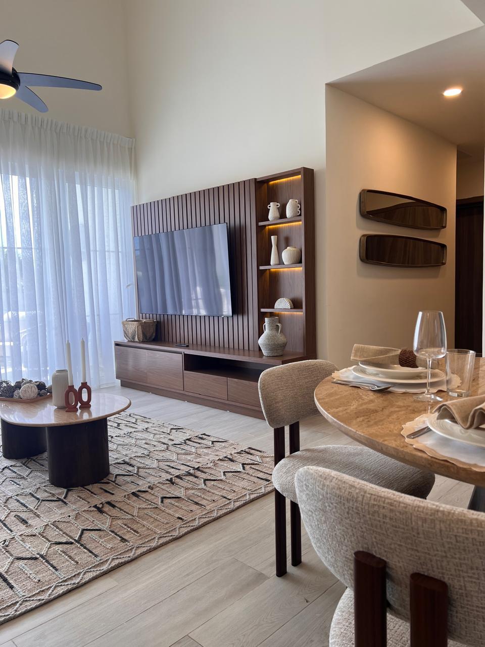 Living and dining with custom wood TV wall | Cocotal furnished 2BR