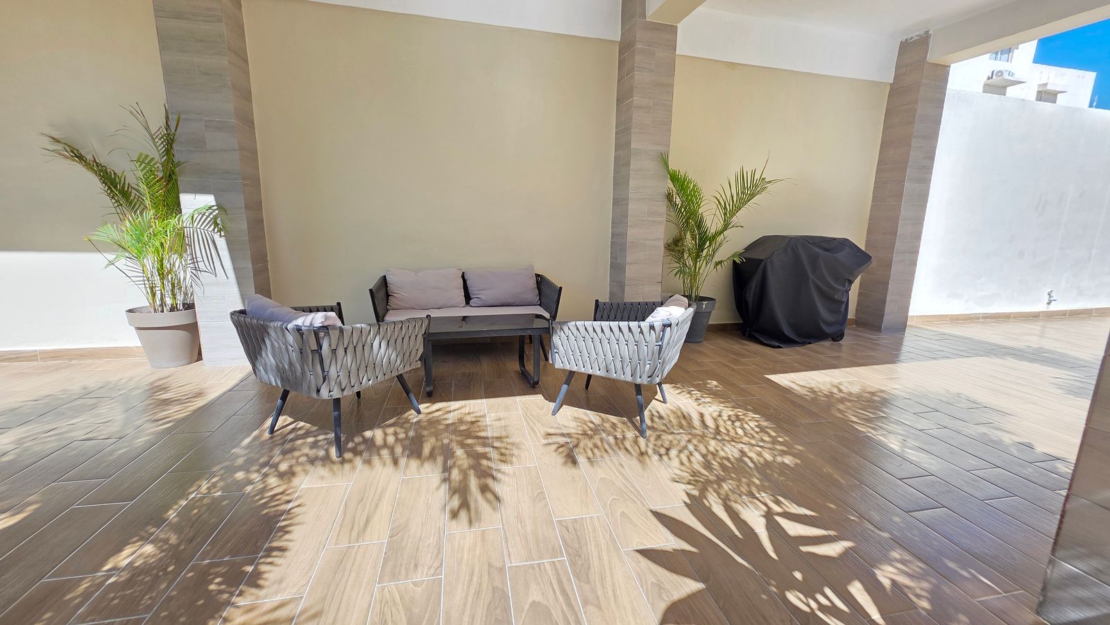 Covered BBQ and lounge area by the pool