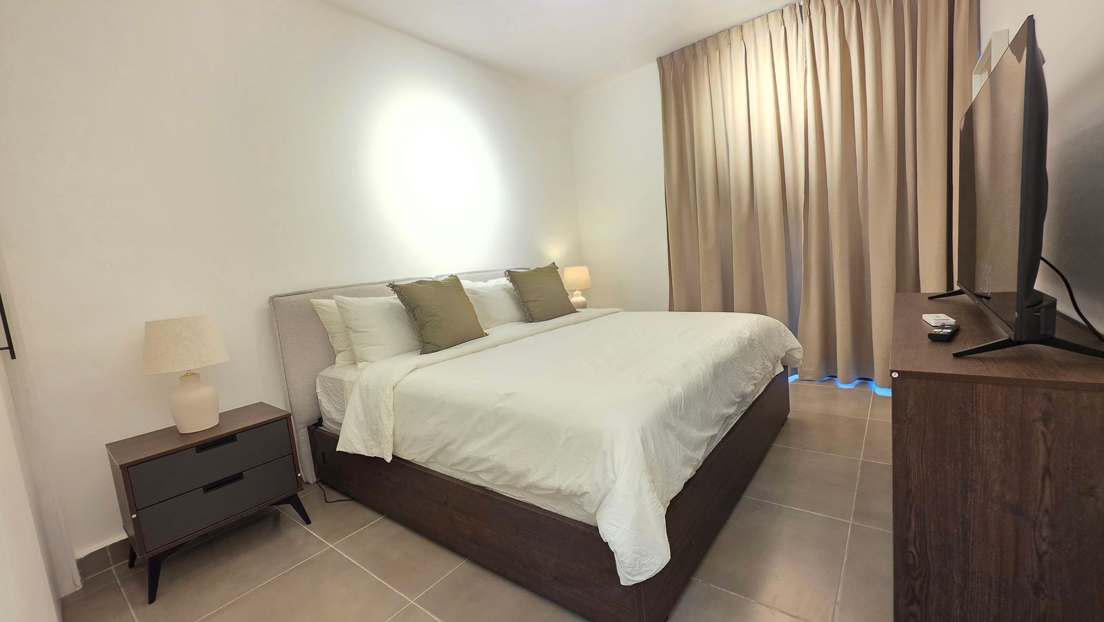 Bedroom with king bed, nightstands and smart TV