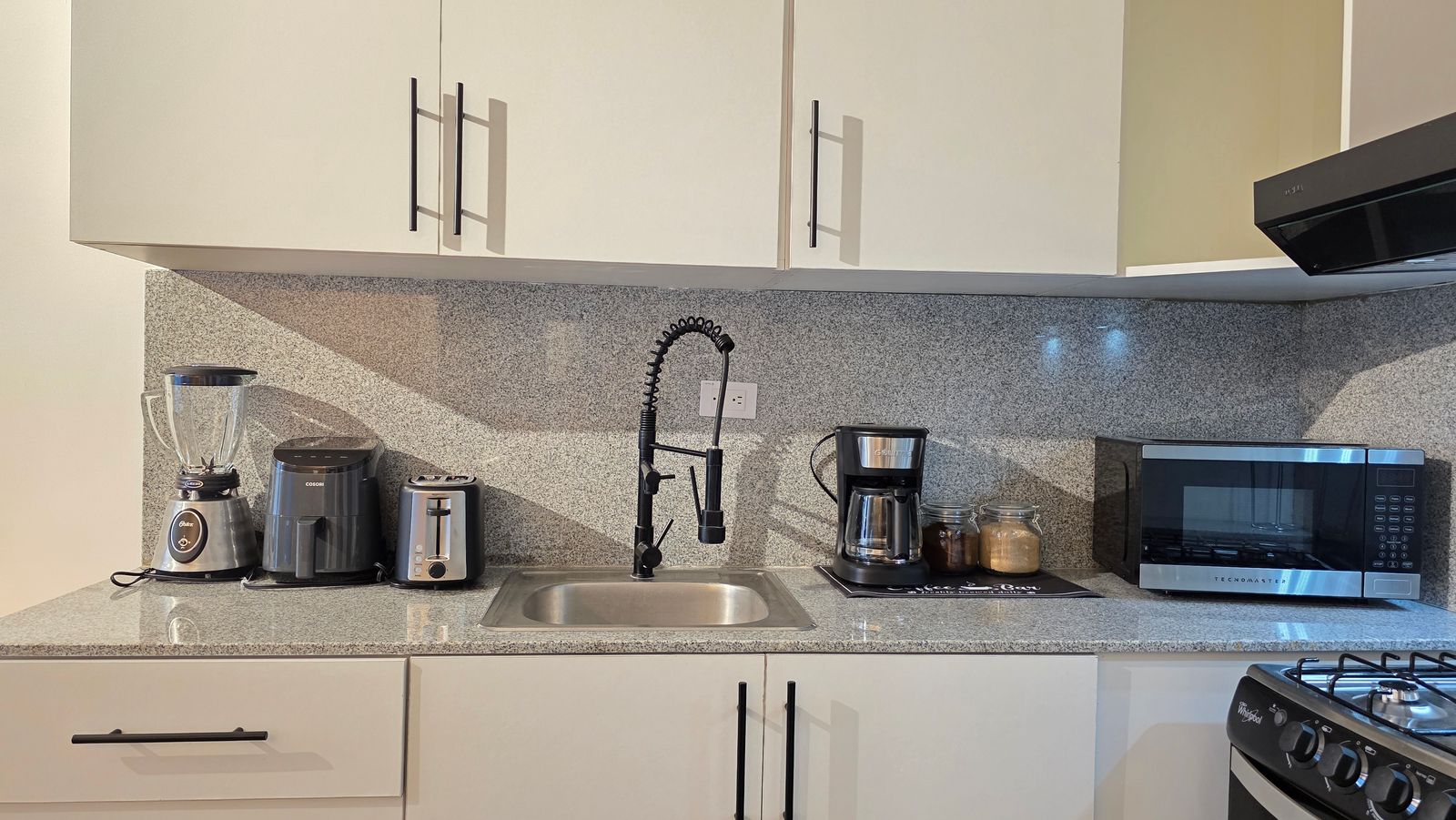 Modern kitchen with granite countertops and appliances