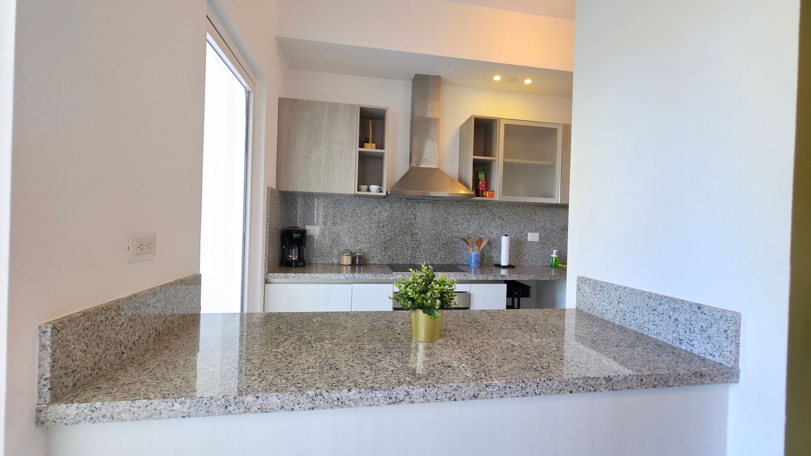 Kitchen with granite countertop and white cabinets