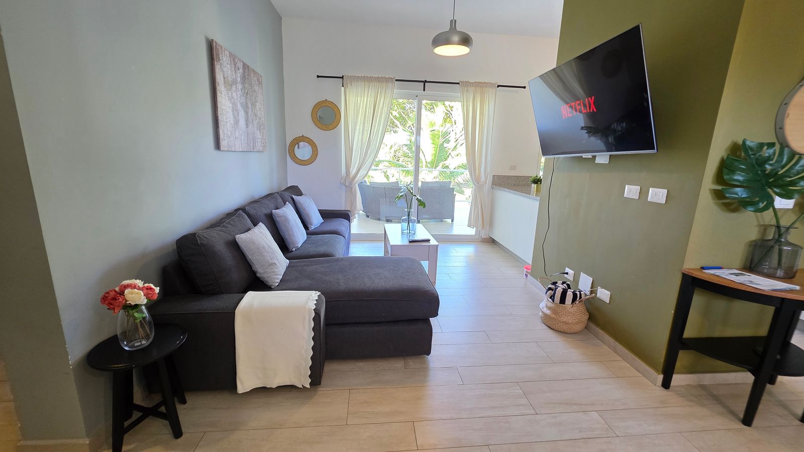 Living room with green accent wall and modern sectional